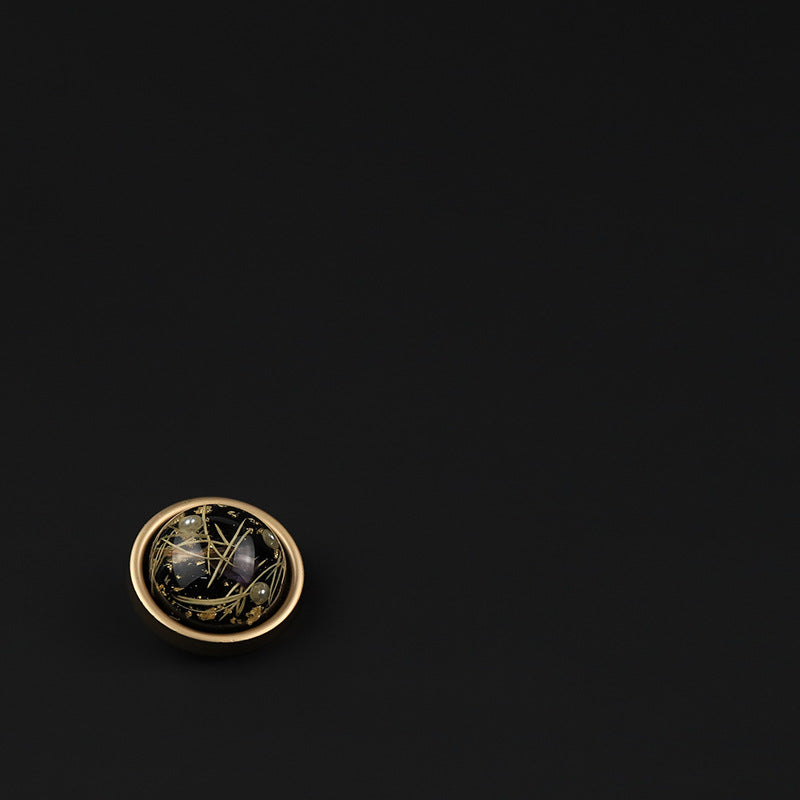 Black round domed button front view on dark background